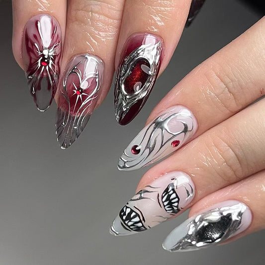 Nails with artistic design featuring red, silver, and black on a gray background