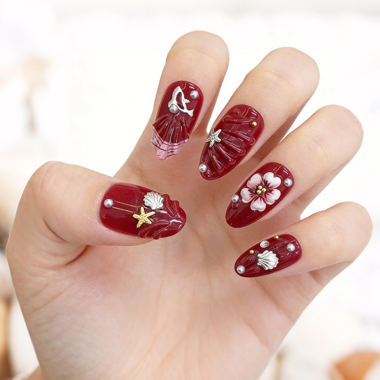 Oceanic Elegance Deep Red Medium Almond Shaped Nail Set with Intricate Floral and Shell Designs