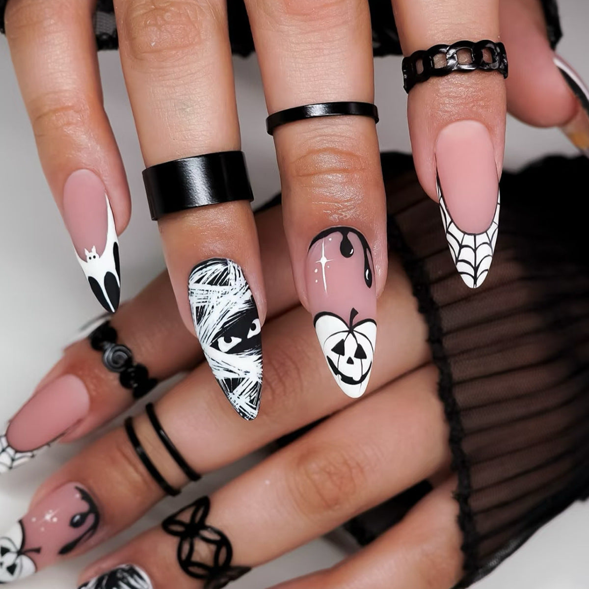 Spooky Elegance Medium Almond Pink and Black Nail Set with Unique Halloween Designs