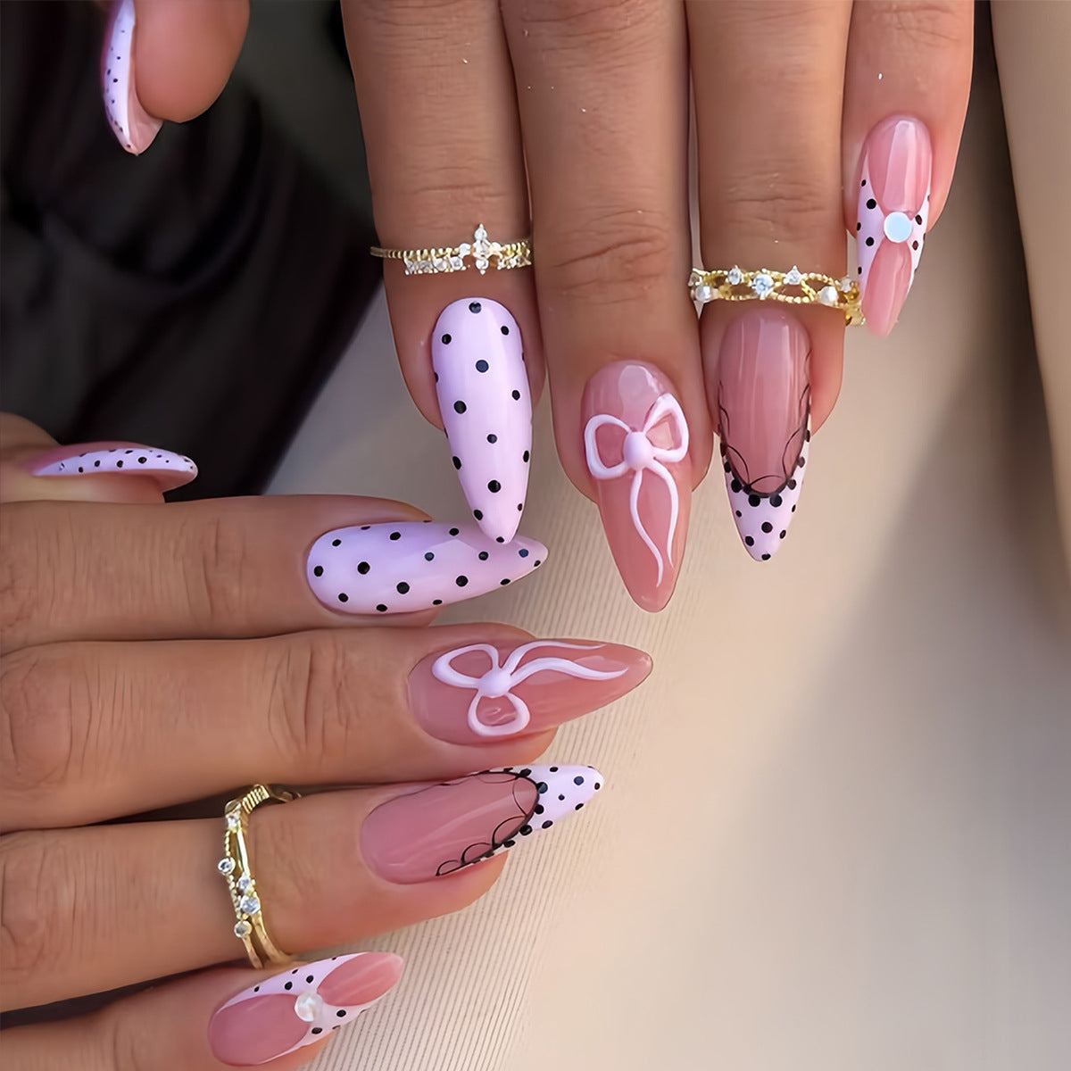Charming Pink Medium Stiletto Nails with Bow Designs and Polka Dots