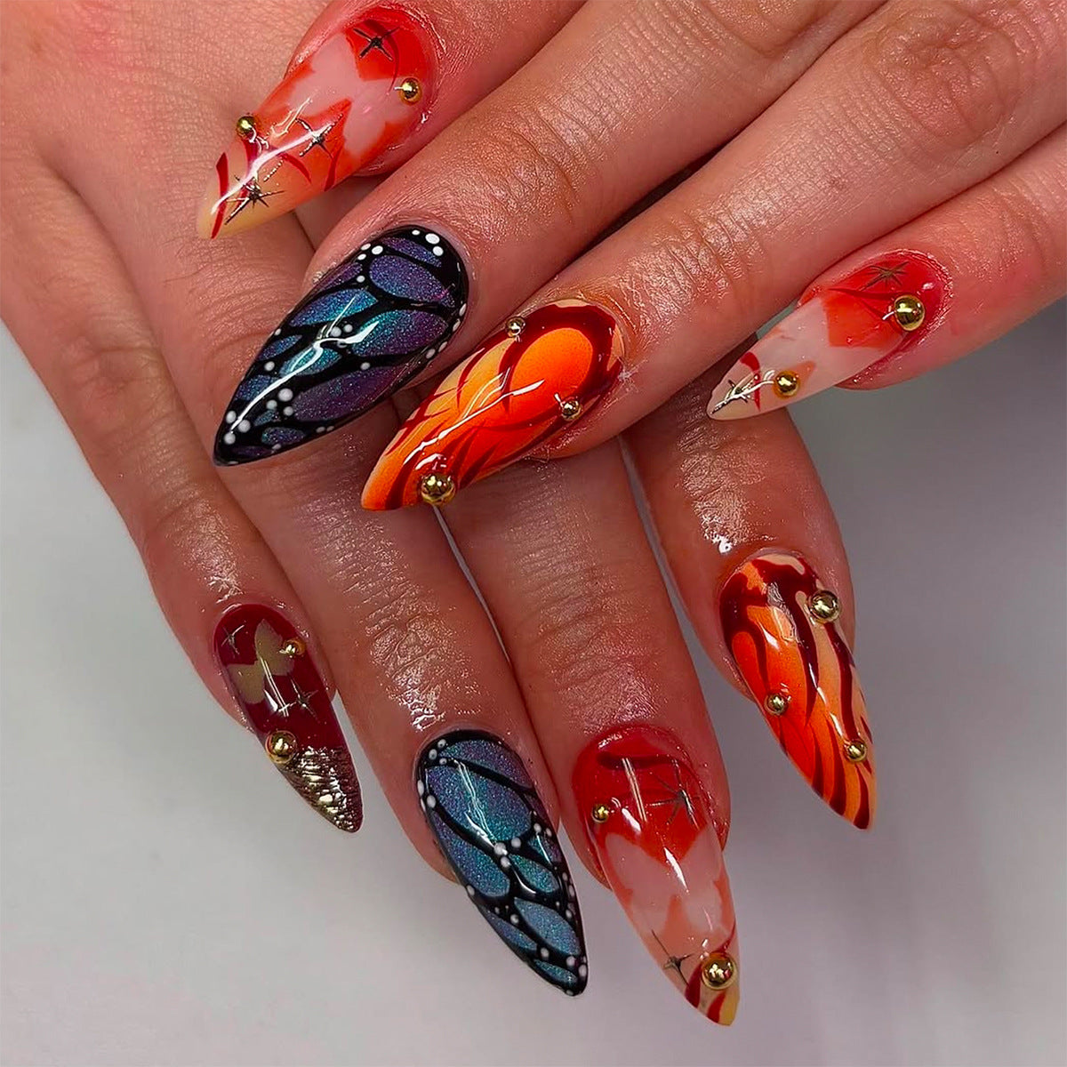 Mystical Fire Medium Almond Orange and Black Press on Nail Set with Unique Decorative Accents