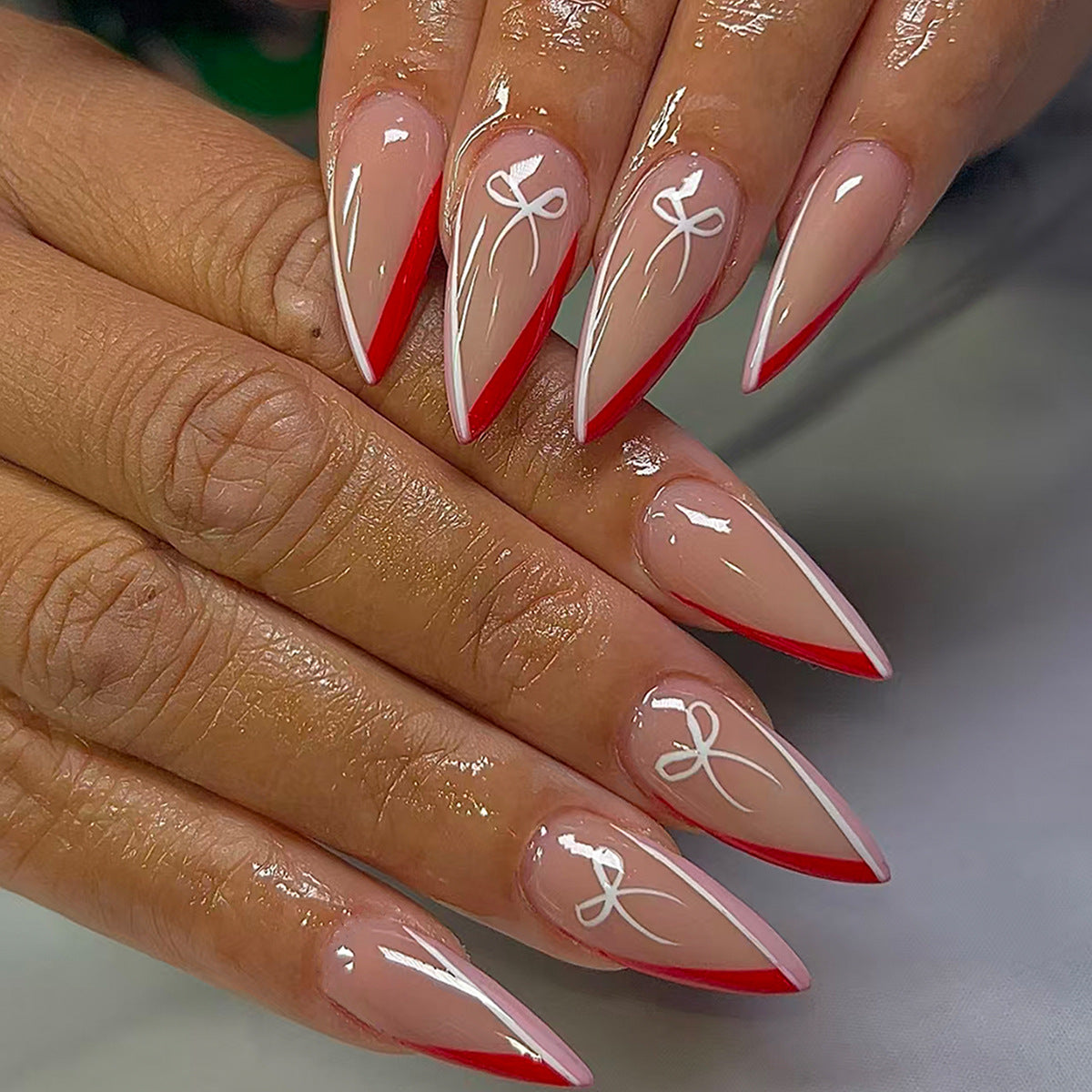 Enchanting Charm Long Stiletto Red Tip Press On Nail Set with Elegant White Design