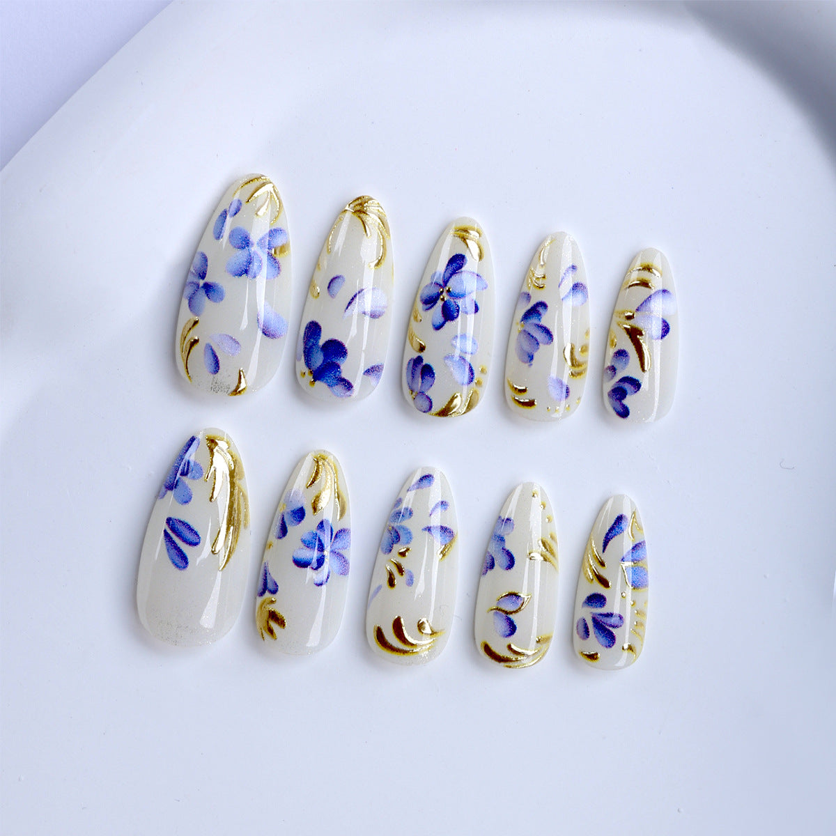 Floral Elegance Medium Almond Clear Nails with Blue and Gold Artistry