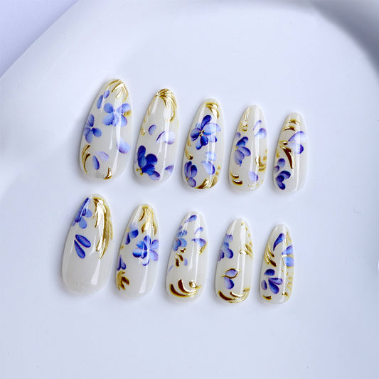 Floral Elegance Medium Almond Clear Nails with Blue and Gold Artistry