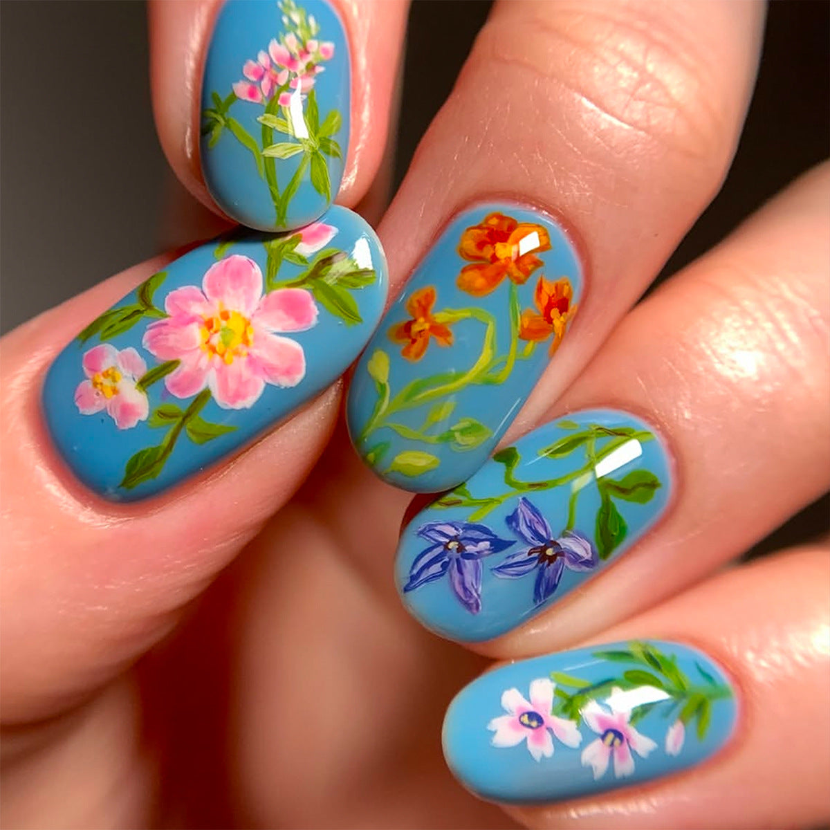 Floral Elegance Medium Oval Sky Blue Nails with Vibrant Hand-Painted Blossoms