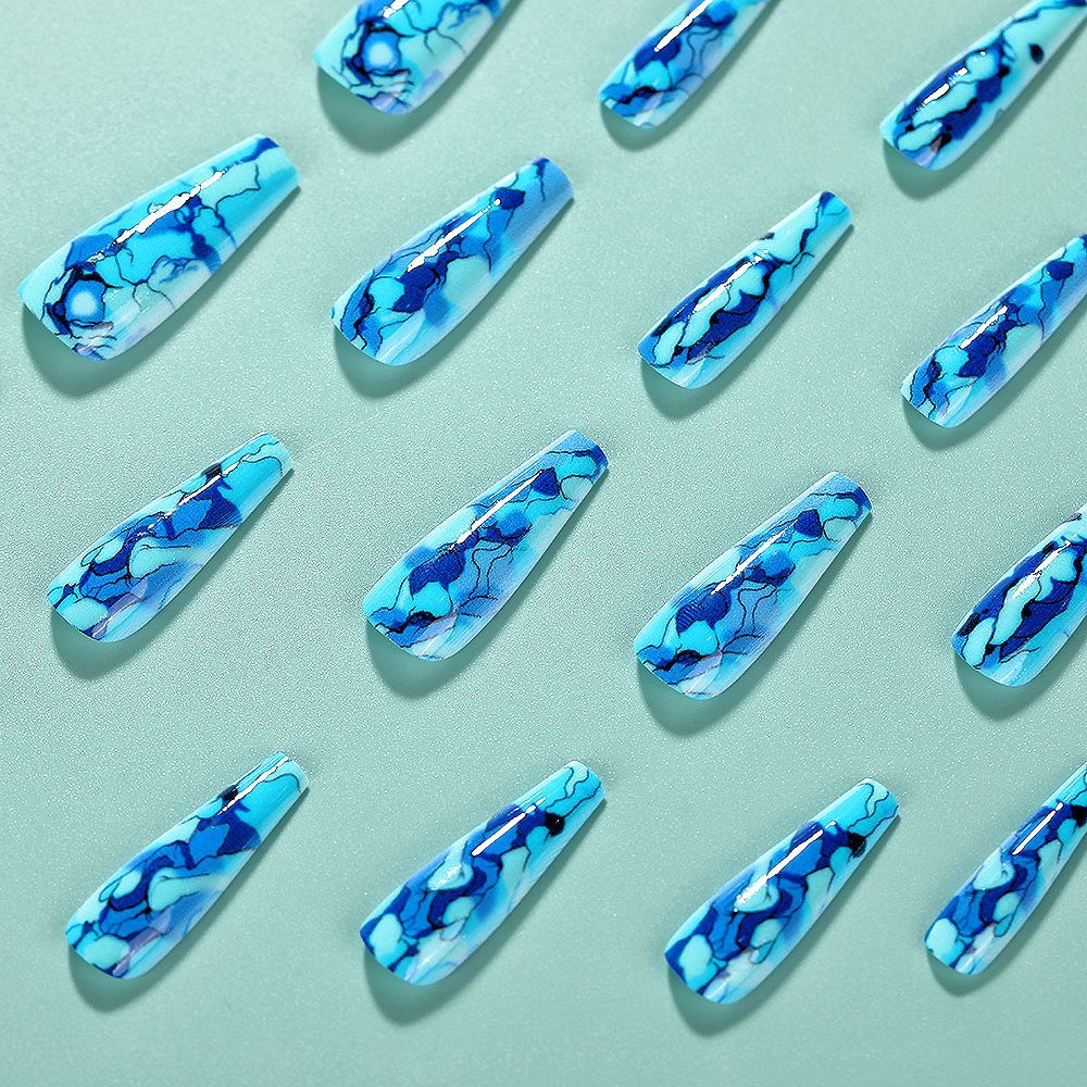 Blue marbled nail art designs on a light blue background