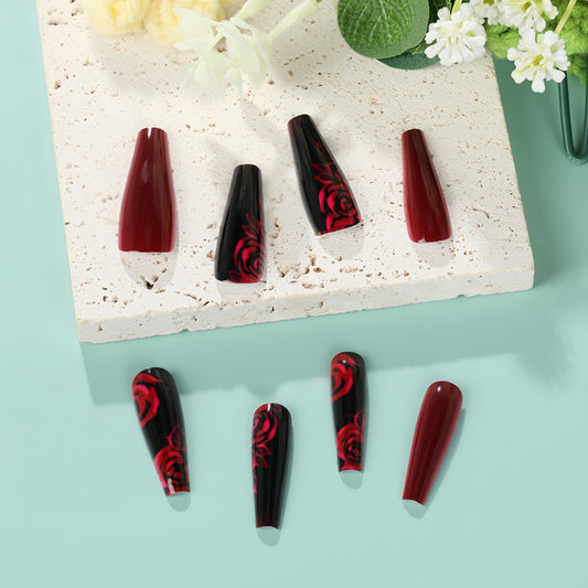 Set of black and red nail art designs on a light blue background with decorative elements.