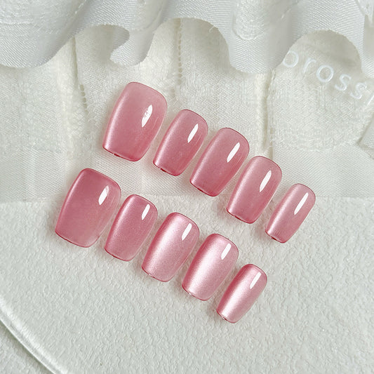 Set of pink nail polish samples on a textured white surface with 'Brossie' branding.