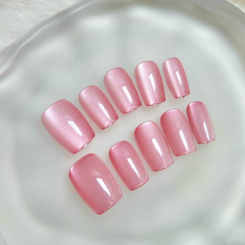 Pink nail polish samples on a reflective surface