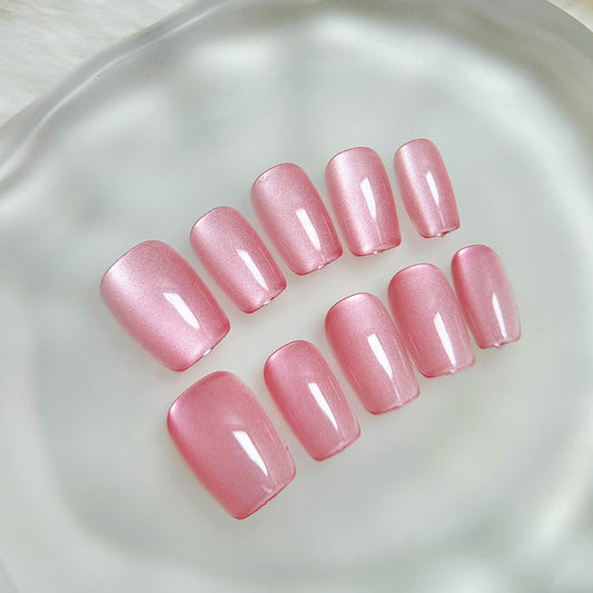 Pink nail polish samples on a reflective surface