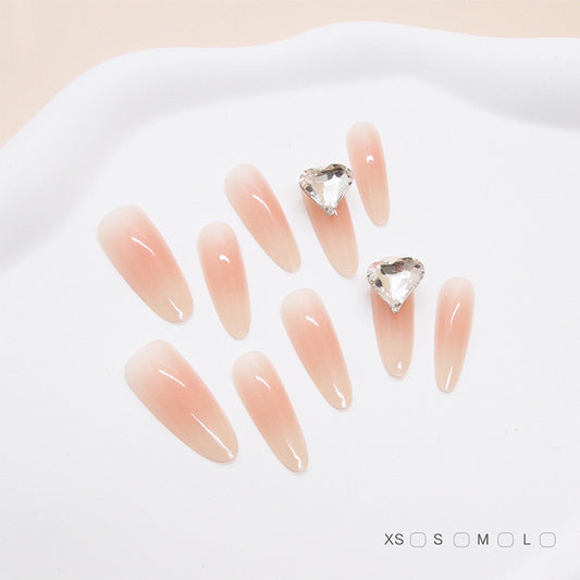 Chic Elegance Long Almond Peach Ombre Nails with Heart Shaped Gemstones
