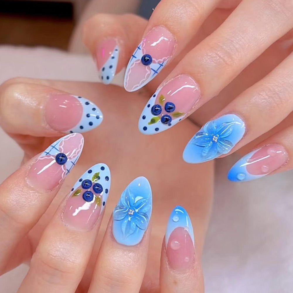 Elegant Floral Escape Medium Almond Blue Press On Nail Set with Decorative Gems and Unique Design