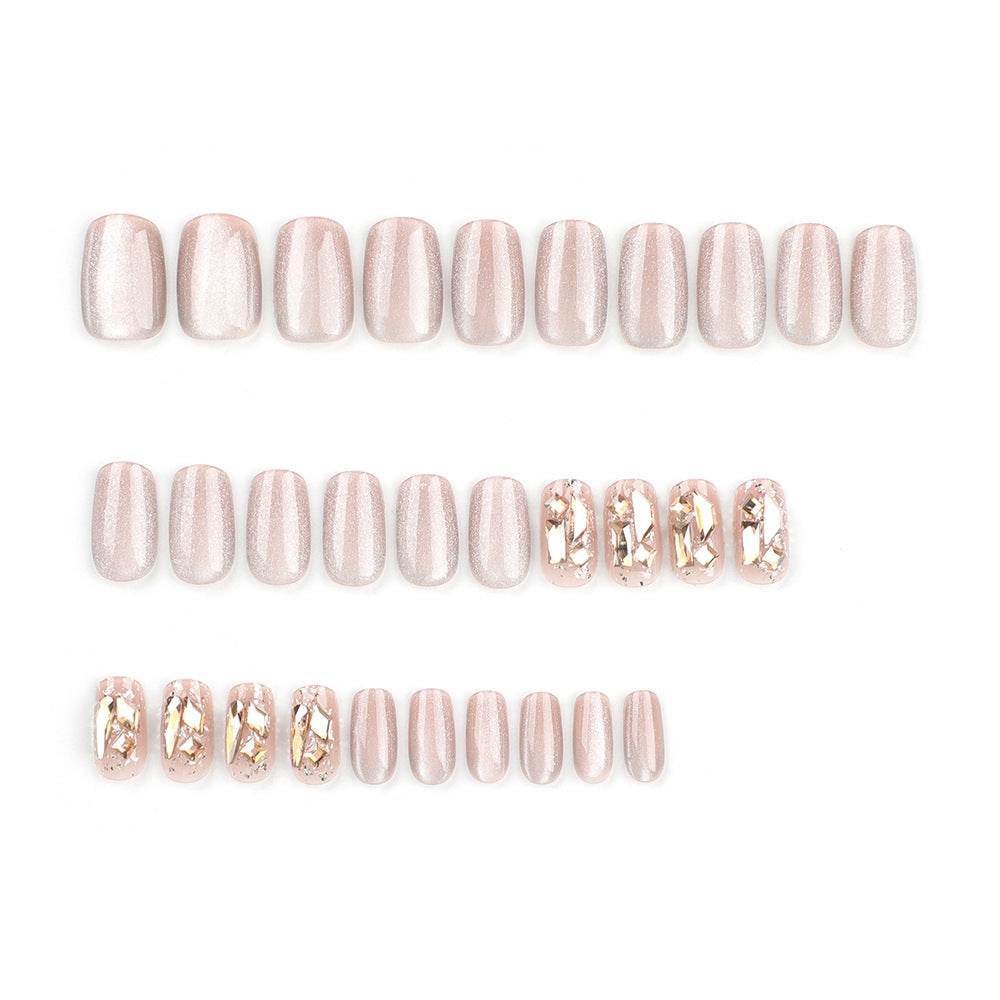 Set of pink nail extensions with gold tips on a white background