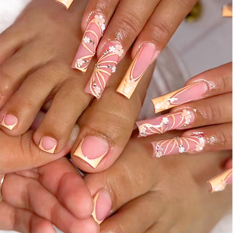 Cherry Blossom Elegance Long Coffin Peach Pink Press On Nail Set with Floral Art and Rhinestone Accents