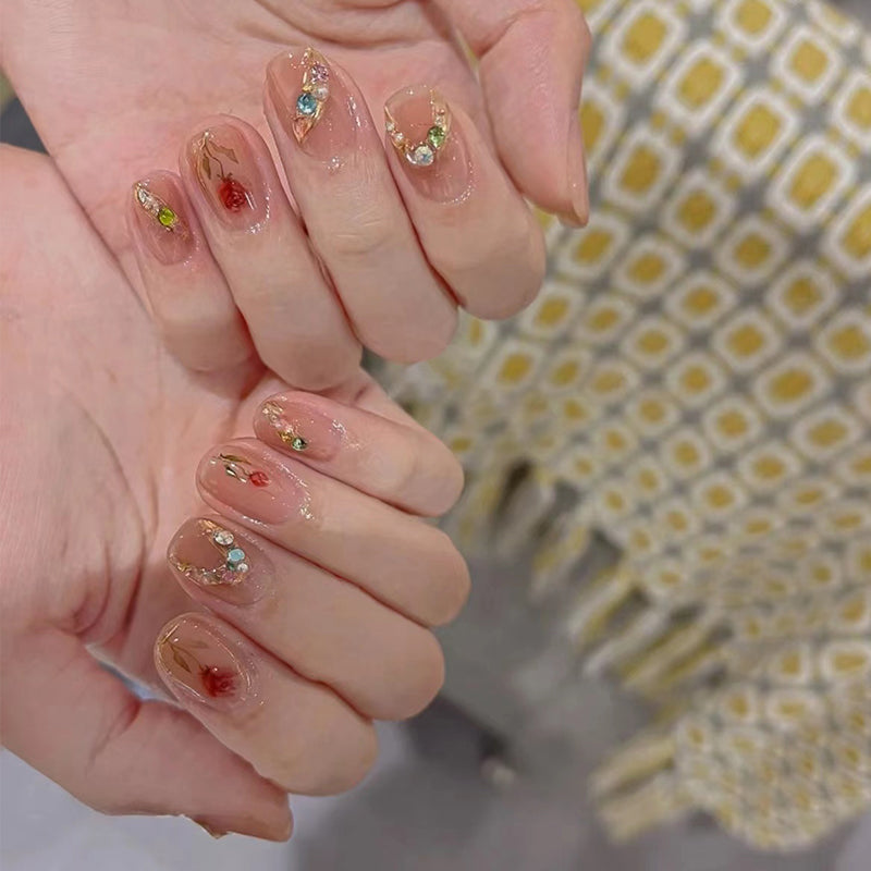 Close-up of hands with decorative nail art against a blurred background