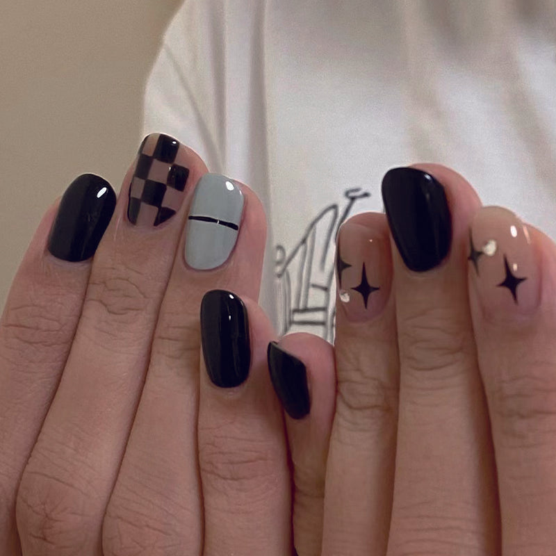 Starry Night Elegance Medium Oval Black and Gray Press On Nails with Star Accents and Checkered Detail