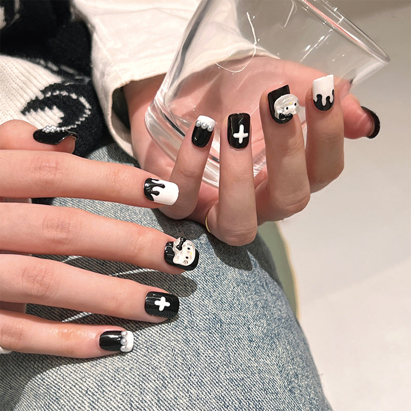Spooky Elegance Medium Squoval Black and White Press On Nails with Embellished Skull and Cross Accents