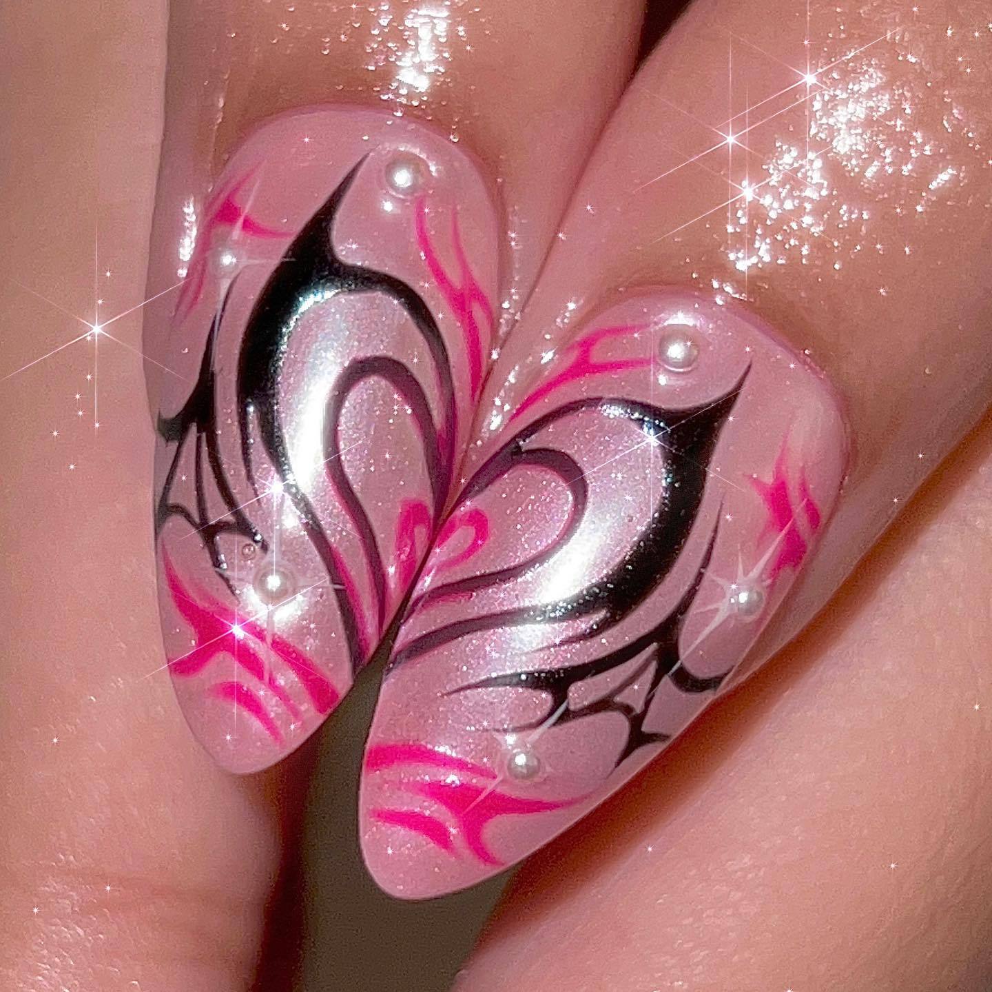 Nail art with pink and black design on a clear background