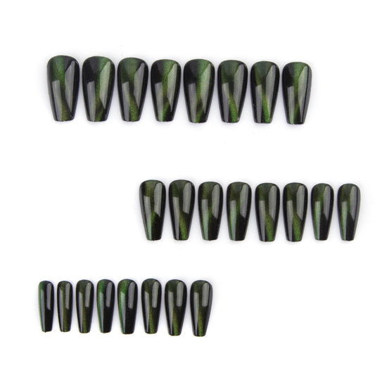 Set of black and green nail extensions on a white background
