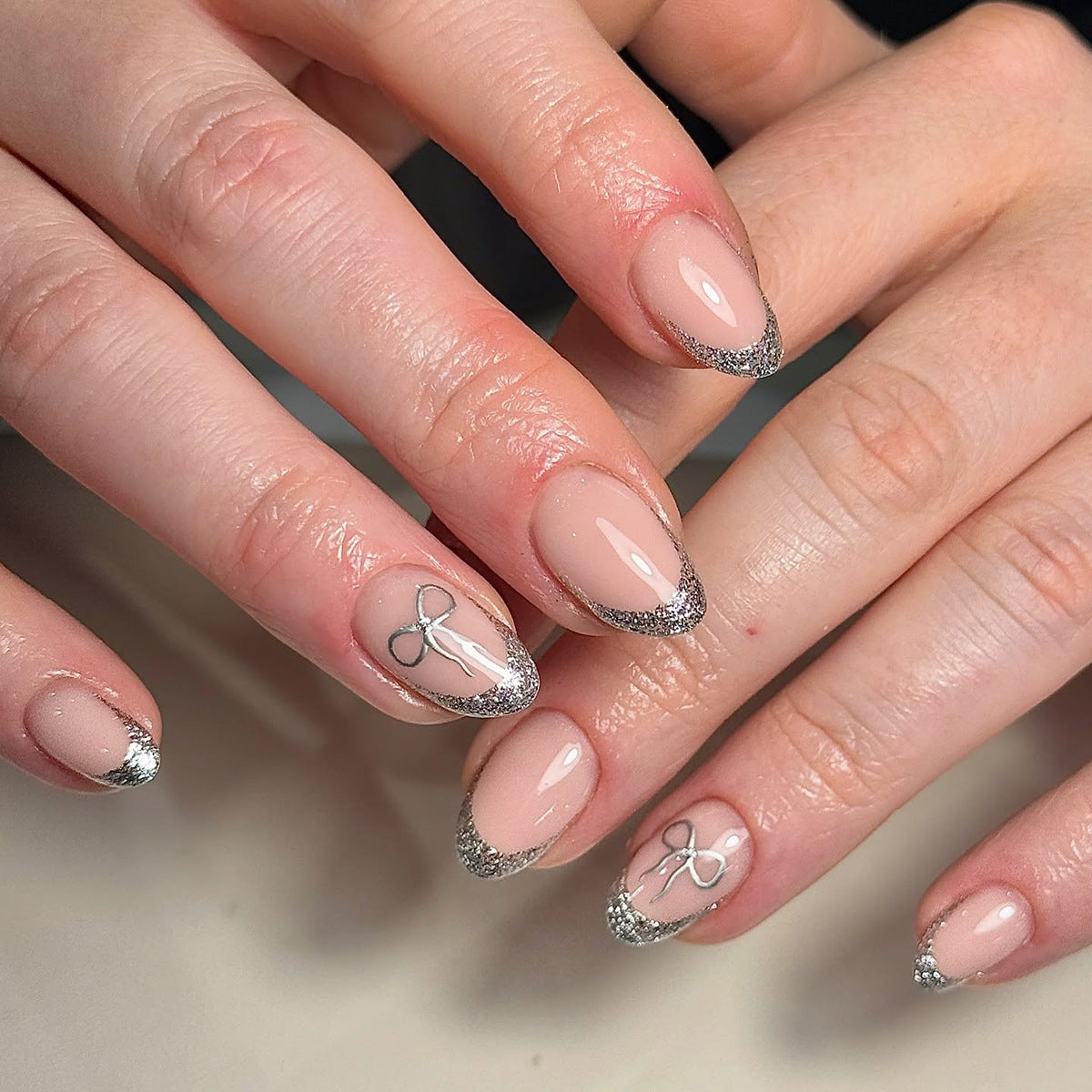 Charming Elegance Medium Almond Beige Glitter French Press On Nail Set with Dainty Bow Accents