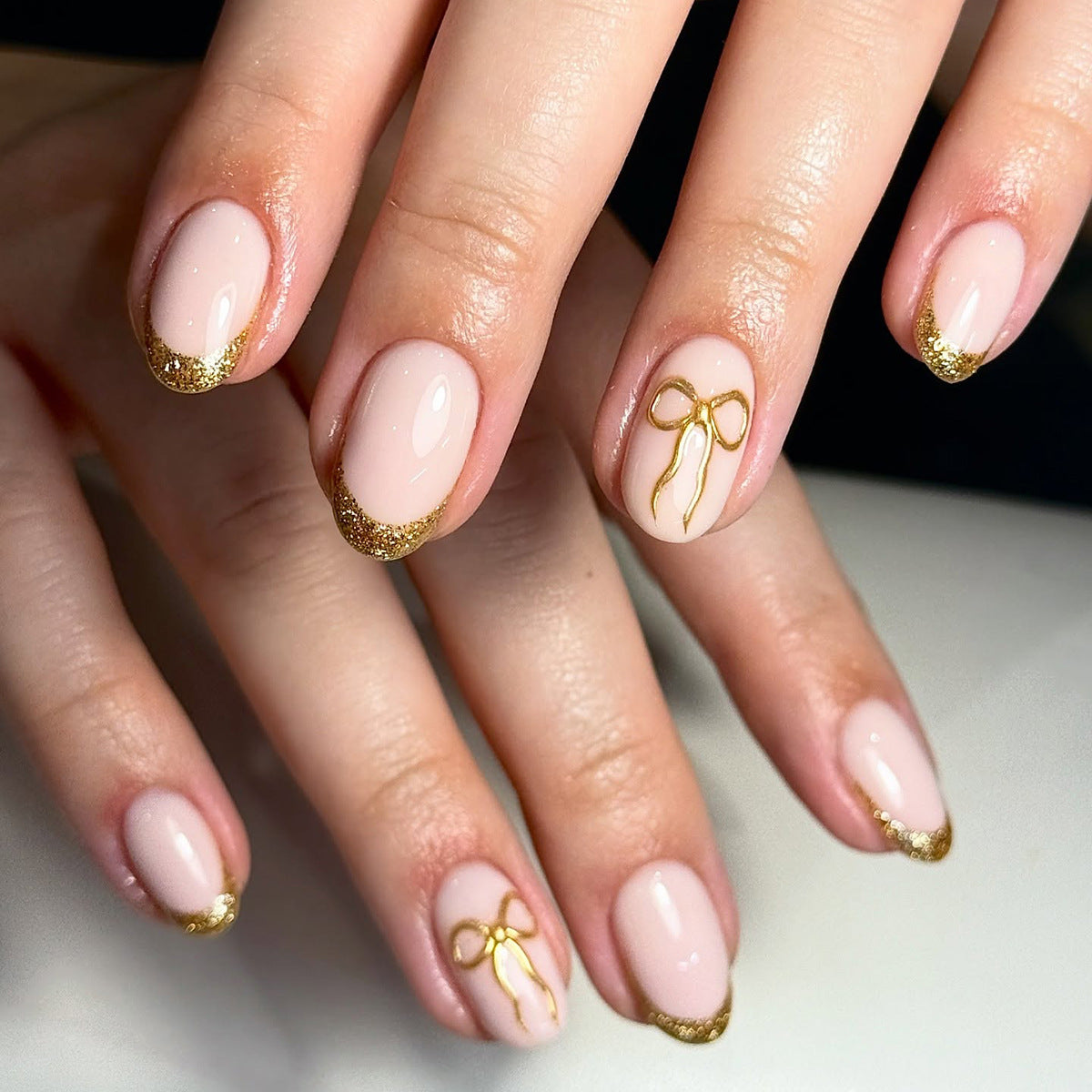 Chic Elegance Medium Oval Soft Pink with Glitter French Tips and Delicate Bow Design