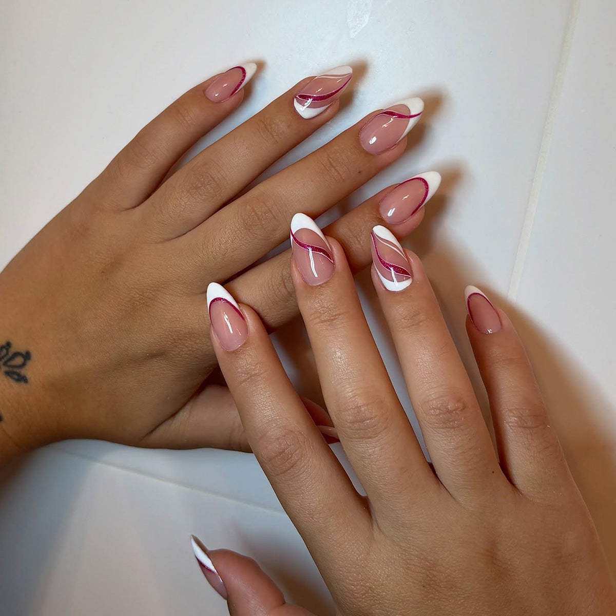 Chic Elegance Long Almond Pink and White Nail Set with Unique Swirl Design