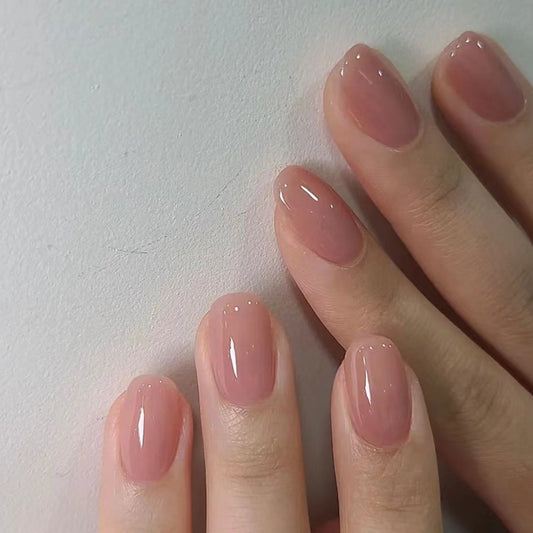 A pair of medium-sized, square-shaped, pink-colored press-on nails.