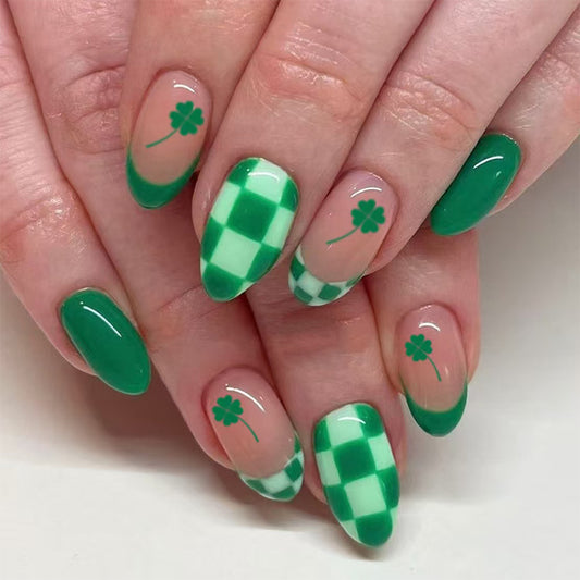 A set of almond-shaped nails with a green and white gingham and floral pattern design.