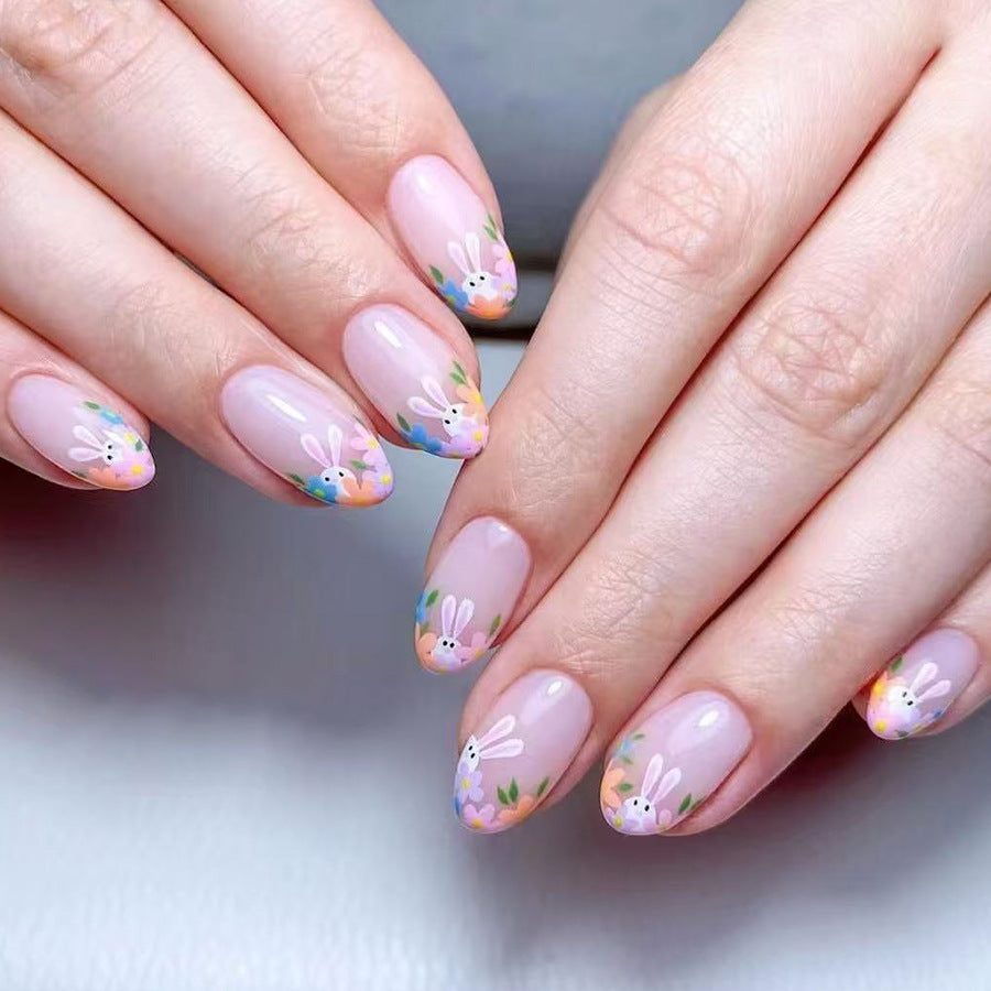 Nails with bunny and flower design on a neutral background