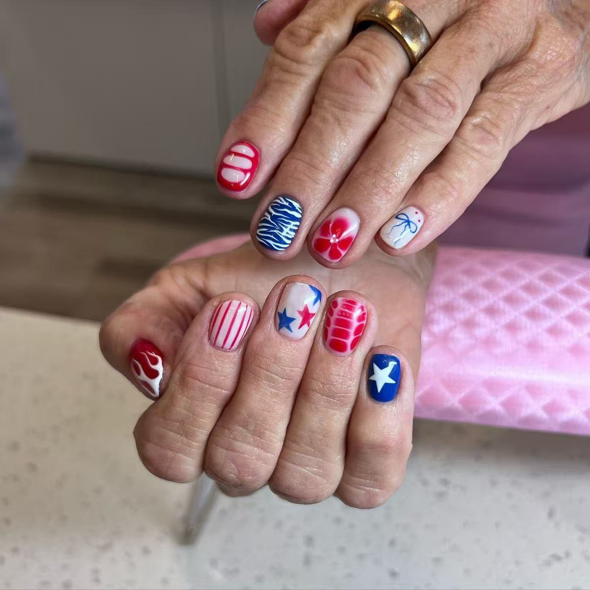 Patriotic Delight Short Squoval Red and Blue Nail Set Featuring Unique Star and Floral Designs