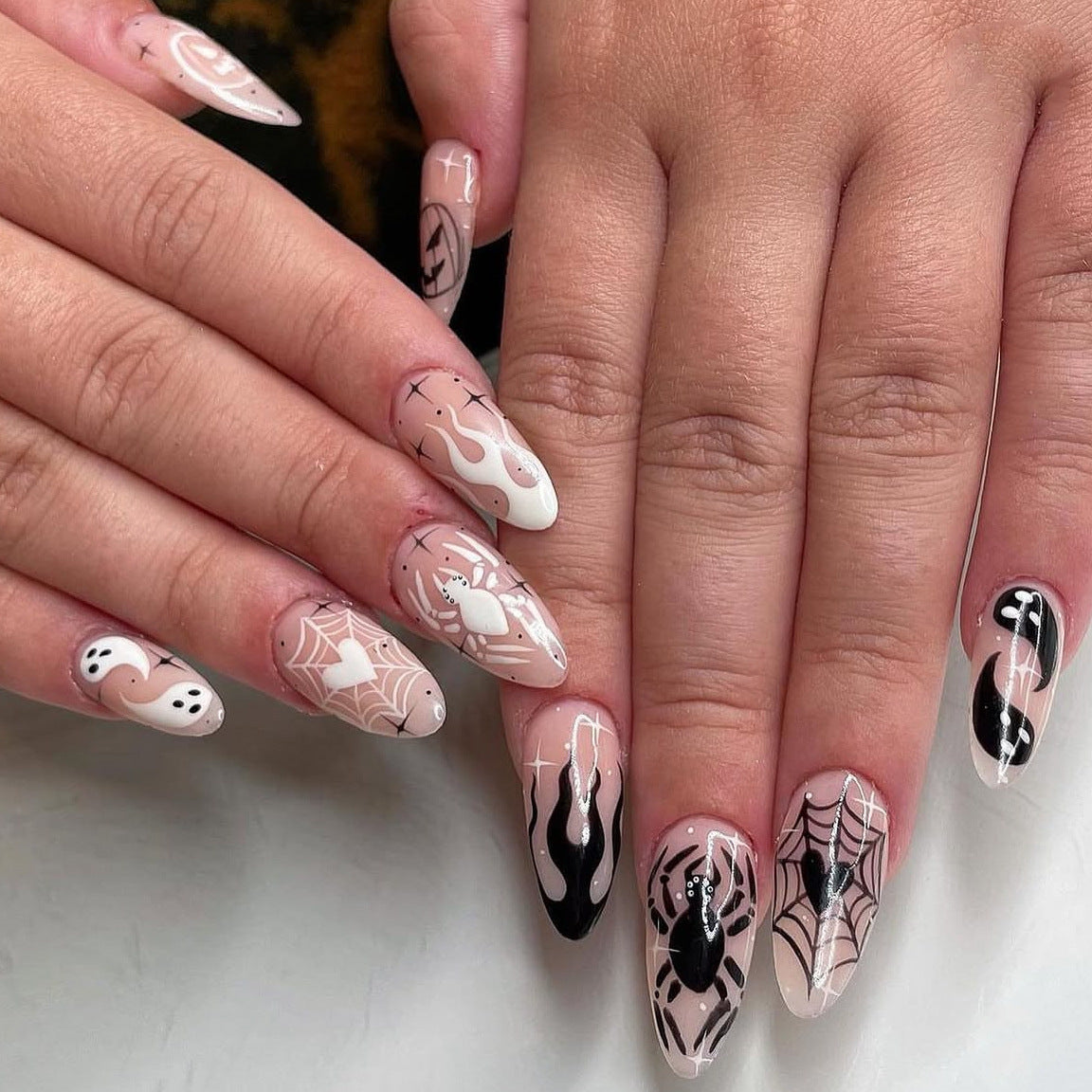 Spooky Glam Medium Almond Beige and Black Nail Set with Intricate Spider Web Designs