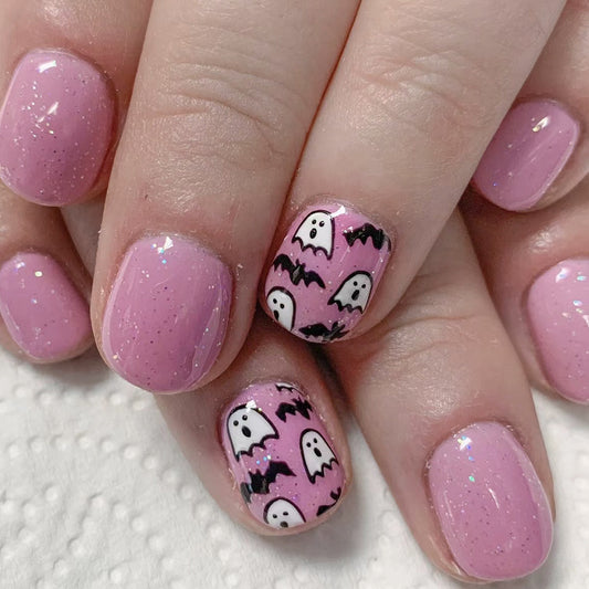 Spooky Elegance Short Oval Pink Press On Nail Set with Glitter Accents and Ghostly Design