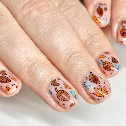 Autumn Harvest Short Oval Peach Nail Set with Whimsical Leaf and Acorn Designs