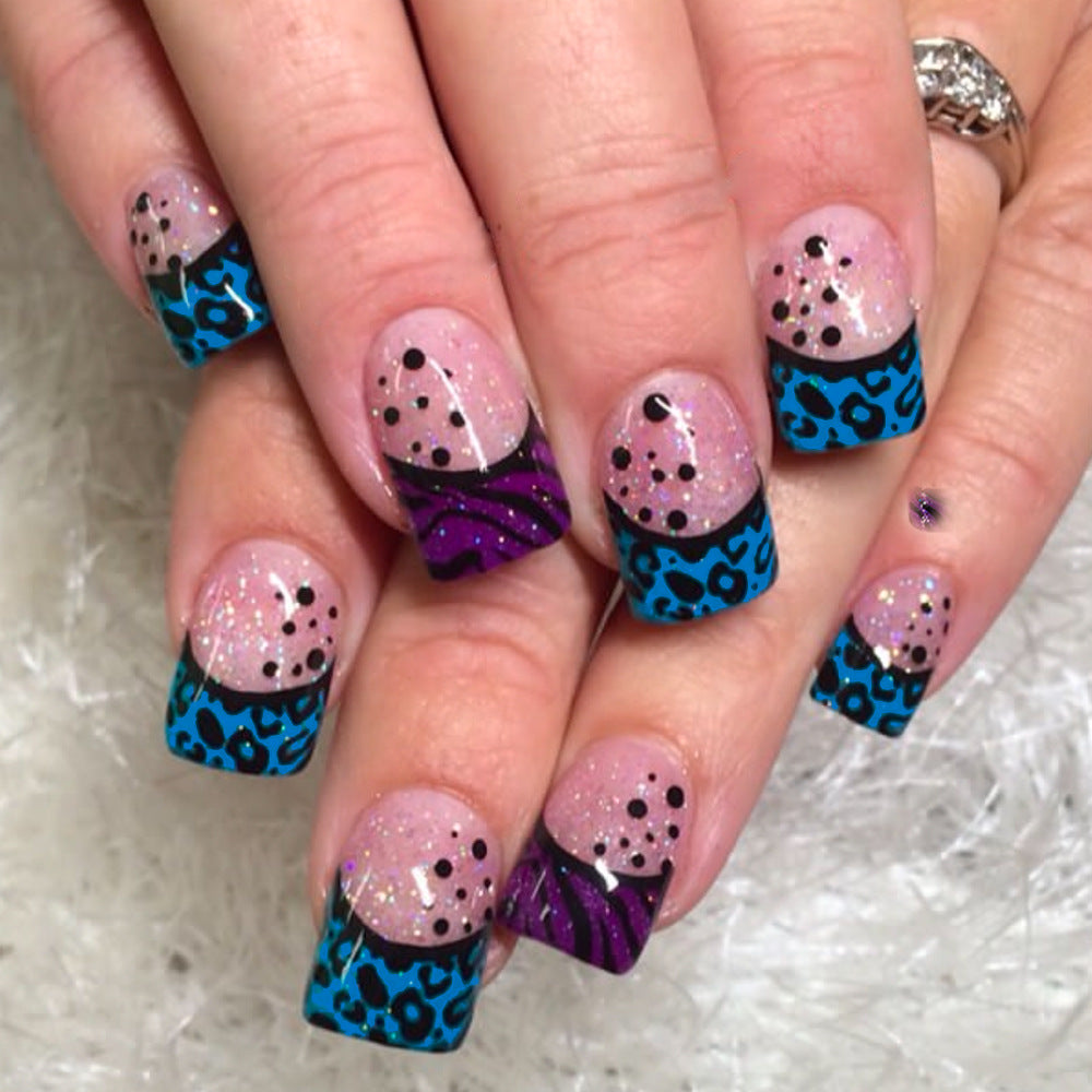 Wild Safari Glamour Press-On Nail Set in Short Squoval Shape featuring Vibrant Blue and Purple Animal Print Design with Dazzling Glitter Accents