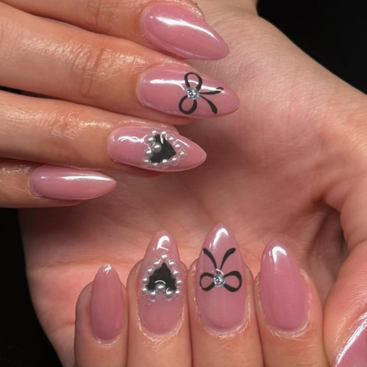 Elegant Charm Pointed Pink Almond Press On Long Nail Set with Black Bows and Pearl Accents