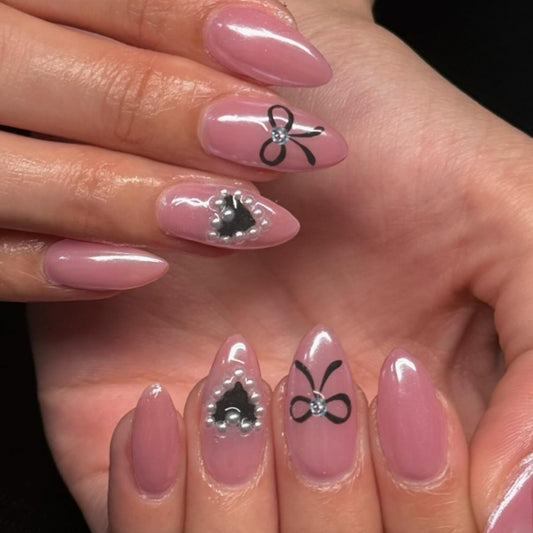 Elegant Charm Pointed Pink Almond Press On Long Nail Set with Black Bows and Pearl Accents