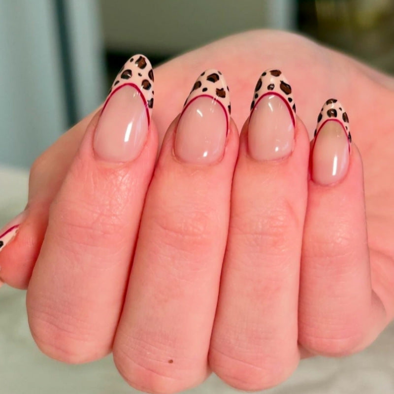 Fierce Jungle Fantasy Short Almond Beige Nails with Leopard Print Tips and Red Accent Line