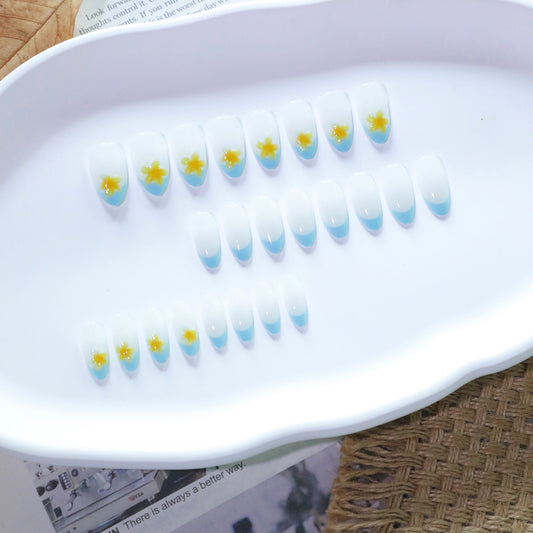 Whimsical Floral Design Medium Almond Shape White with Blue Tips and Delightful Yellow Flower Accents Press On Nail Set