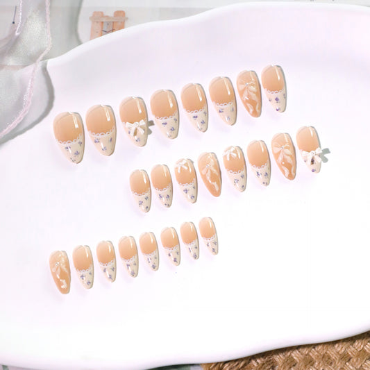 Whimsical Garden Inspired Medium Almond Beige Press-On Nail Set with Delicate Floral Accents and Charming Bow Details