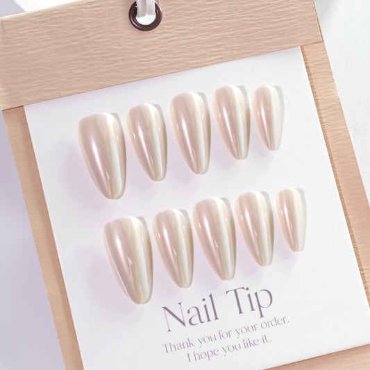 Set of nail tips on a display card with a wooden frame.