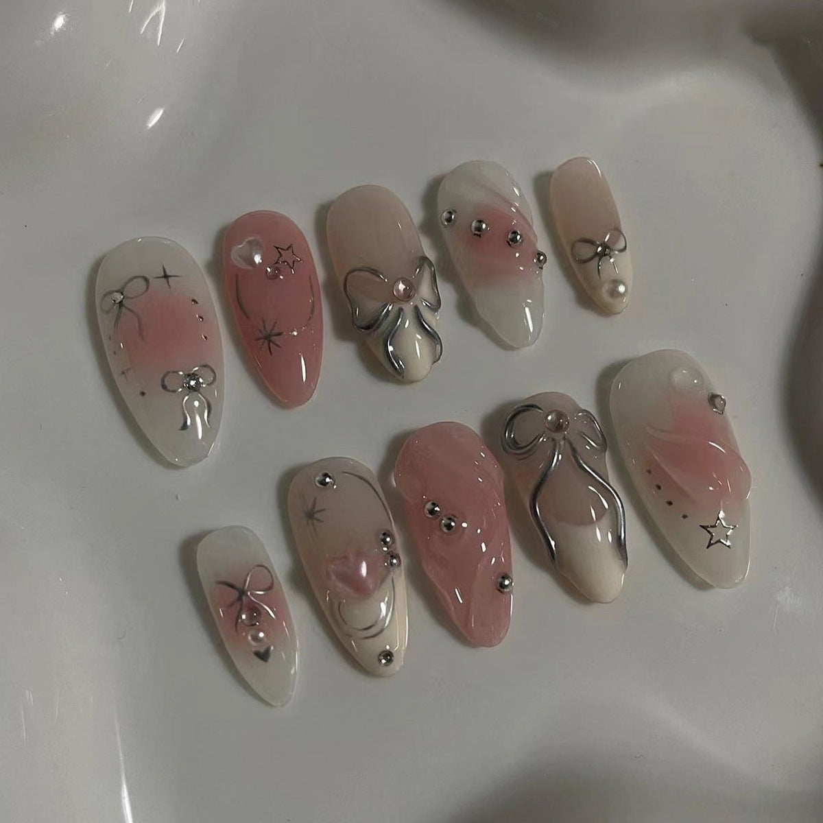 Elegant Marble Bliss Medium Almond Pink Press On Nails with Silver Embellishments and Charms