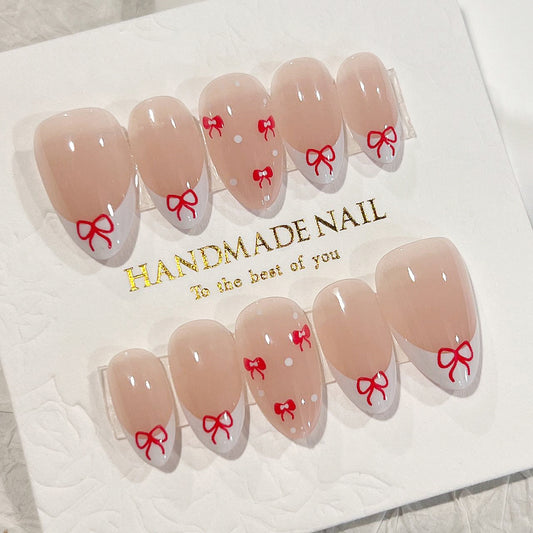 Enchanted Elegance Medium Almond Beige Press On Nails with Red Bow Accents and Polka Dot Charms