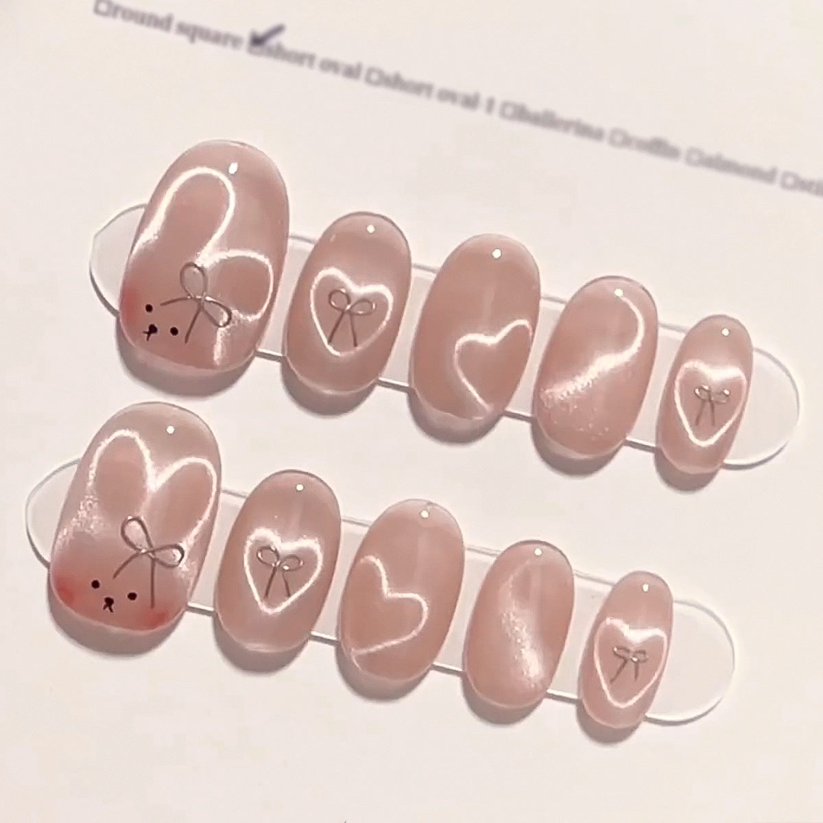 Enchanted Romance Medium Oval Blush Pink Press On Nails with Delicate Heart Accents and Sheer Finish