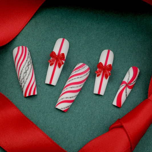 Holiday Spirit Festive Long Coffin Red and White Candy Stripe Nails with Charming Bow Accents