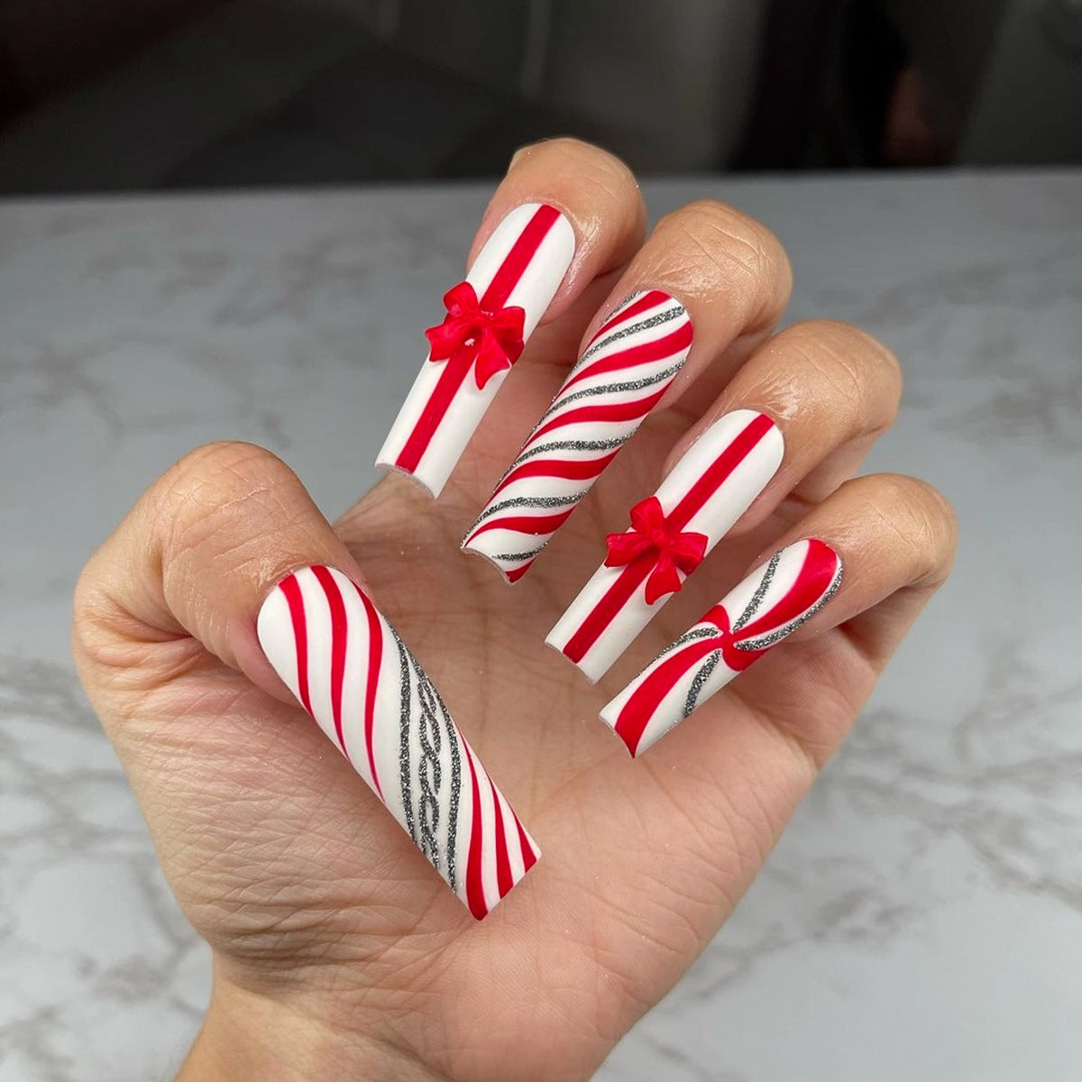 Festive Candy Cane Long Square Red and White Striped Nails with Bow Accents