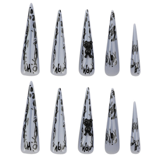 A set of press-on nails featuring a stiletto shape in gray with unique bear accents and a gothic aesthetic.
