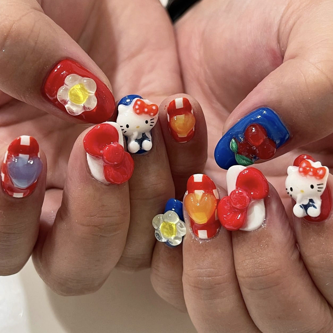 Hello Kitty Inspired Charming Short Squoval Press On Nail Set In Red And Blue With Adorable 3D Characters And Colorful Accents
