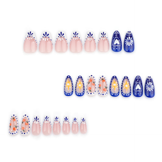 A set of almond-shaped light pink and blue false nails with floral and other artistic designs.