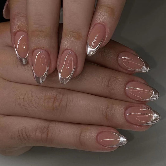 Close-up of hands with pink and silver nail polish on a neutral background