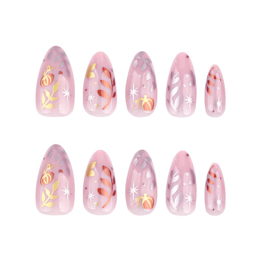 A set of almond-shaped pink false nails with glittery holiday designs, including stars and snowflakes.